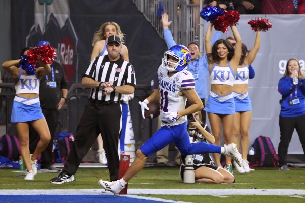 Bean throws for 6 TDs Kansas overcomes flags to beat UNLV 49 36